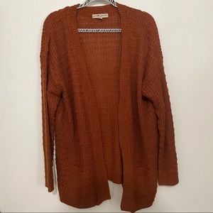Rust orange colored long sleeved cardigan